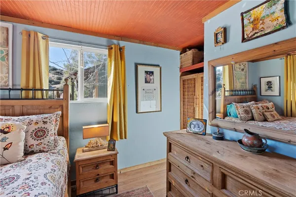 a bedroom with a bed and a chair