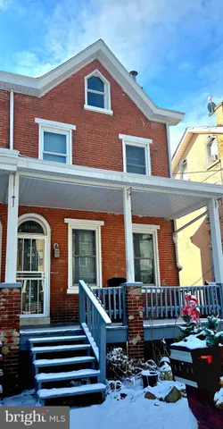 a front view of house with outdoor seating