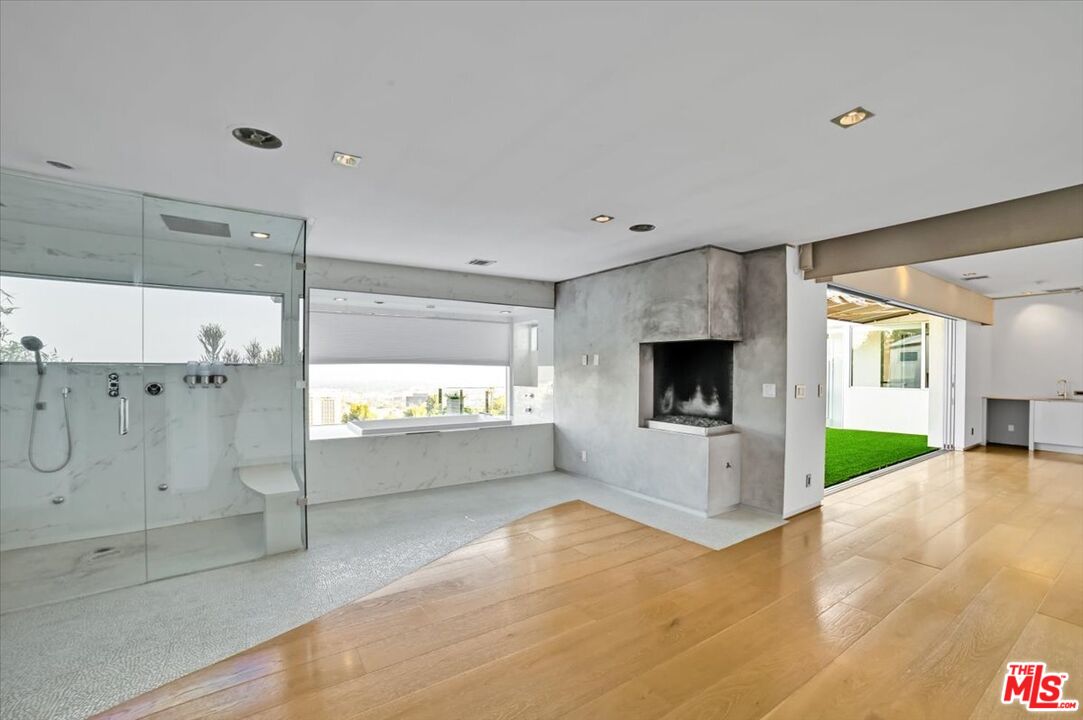7044 Los Tilos Road Los Angeles, CA 90068 - Photo 11 of 58 a view of empty room with window and fireplace