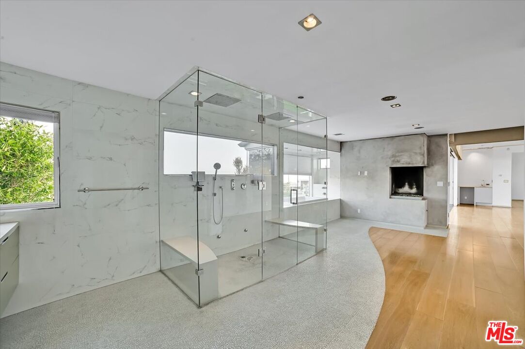 7044 Los Tilos Road Los Angeles, CA 90068 - Photo 12 of 58 a spacious bathroom with a glass shower door and a sink