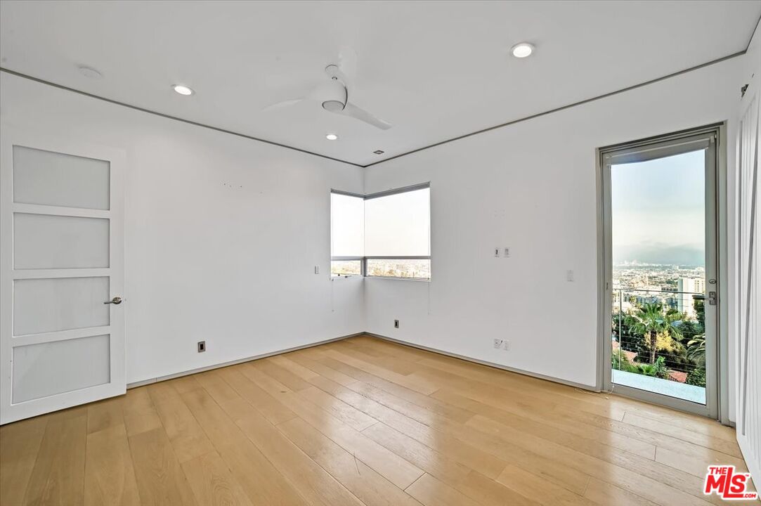 7044 Los Tilos Road Los Angeles, CA 90068 - Photo 20 of 58 a view of a big room with wooden floor and windows