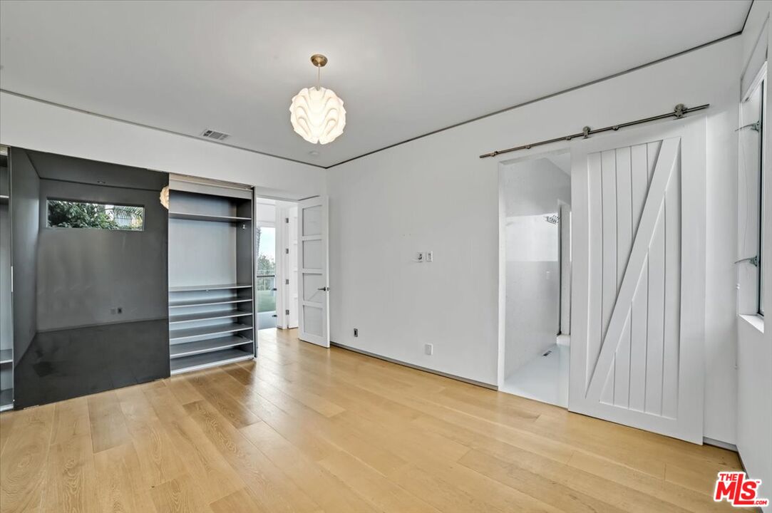 7044 Los Tilos Road Los Angeles, CA 90068 - Photo 24 of 58 an empty room with wooden floor and windows