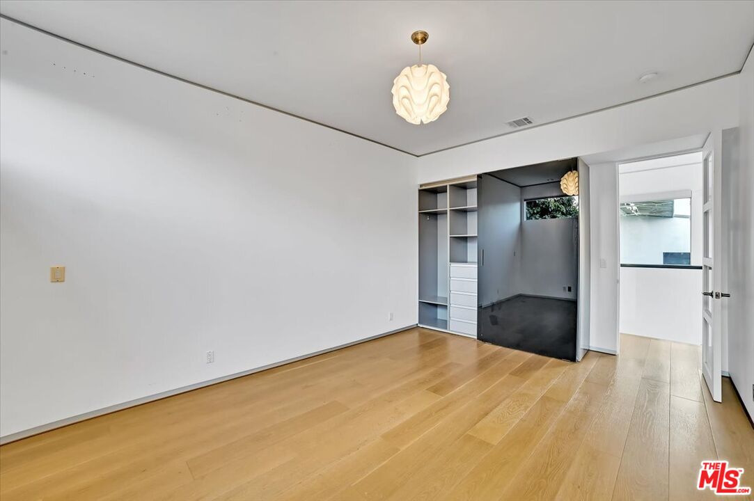 7044 Los Tilos Road Los Angeles, CA 90068 - Photo 25 of 58 a view of empty room with wooden floor