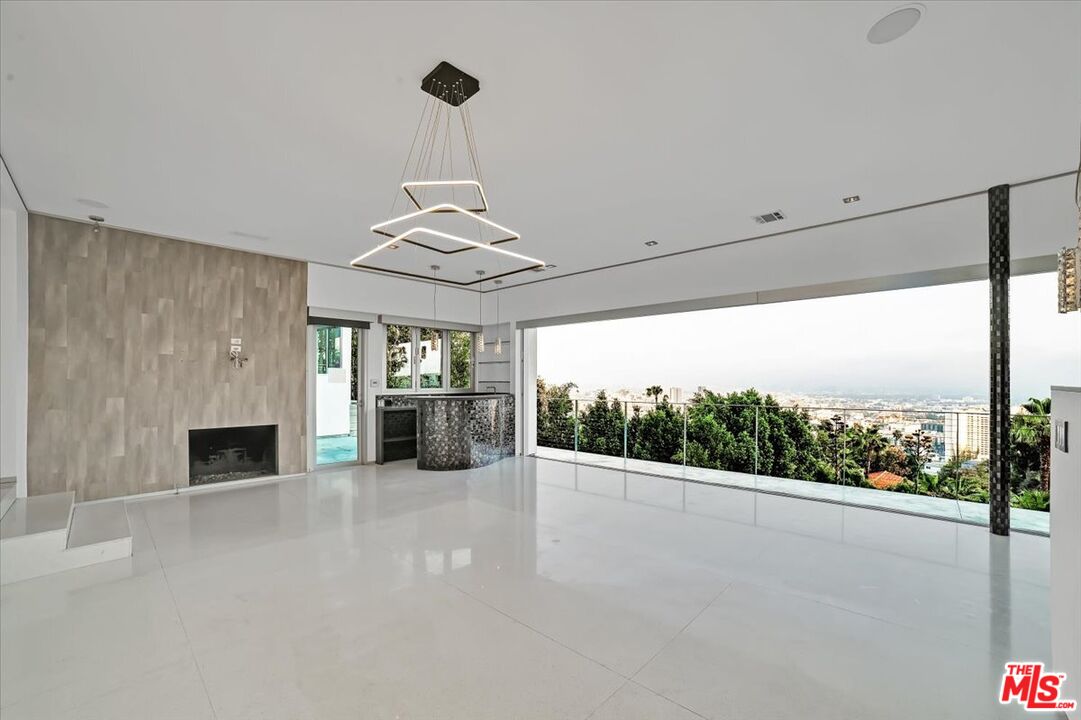 7044 Los Tilos Road Los Angeles, CA 90068 - Photo 27 of 58 a view of an empty room with window and chandelier