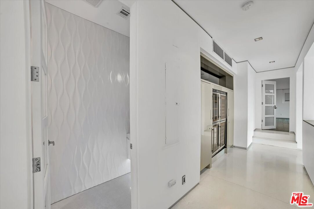 7044 Los Tilos Road Los Angeles, CA 90068 - Photo 36 of 58 a view of a hallway with wooden shelves