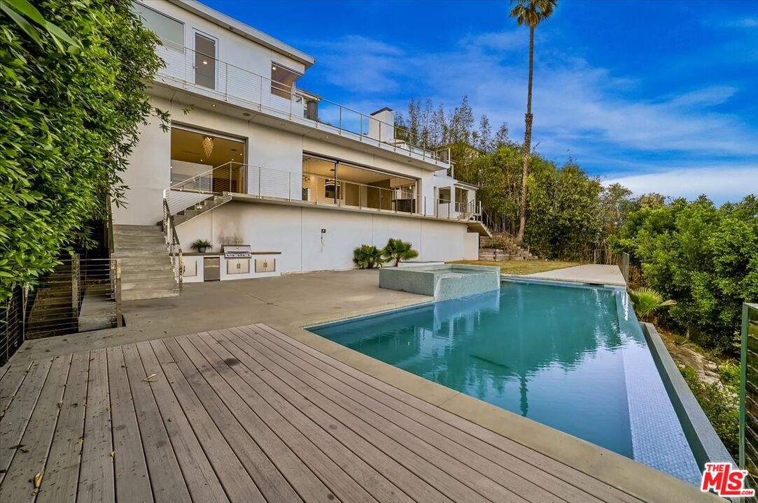 7044 Los Tilos Road Los Angeles, CA 90068 - Photo 47 of 58 a view of a balcony with two chairs and wooden floor
