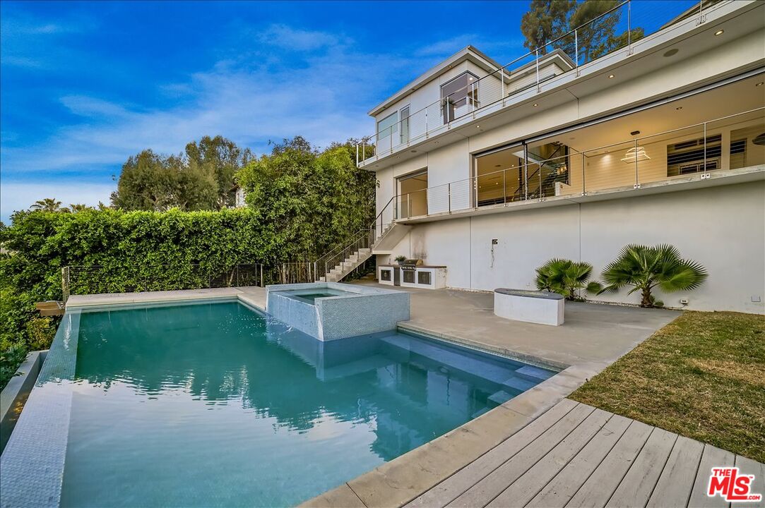 7044 Los Tilos Road Los Angeles, CA 90068 - Photo 48 of 58 a view of a swimming pool with a patio