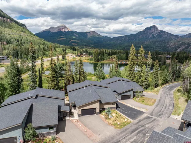 an aerial view of a house with a yard
