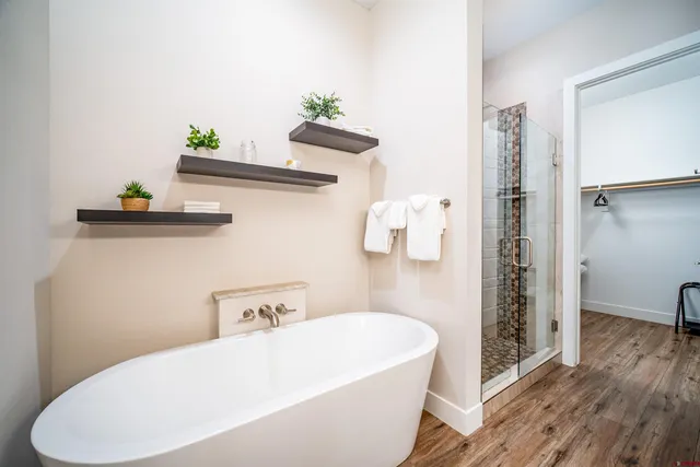a white bath tub sitting next to a white toilet