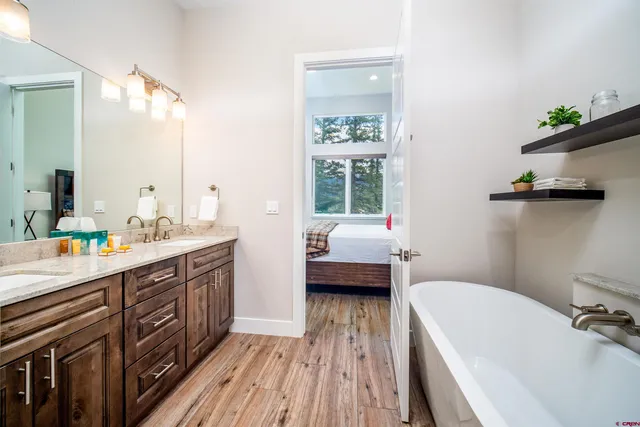 a bathroom with a sink a mirror and a bathtub