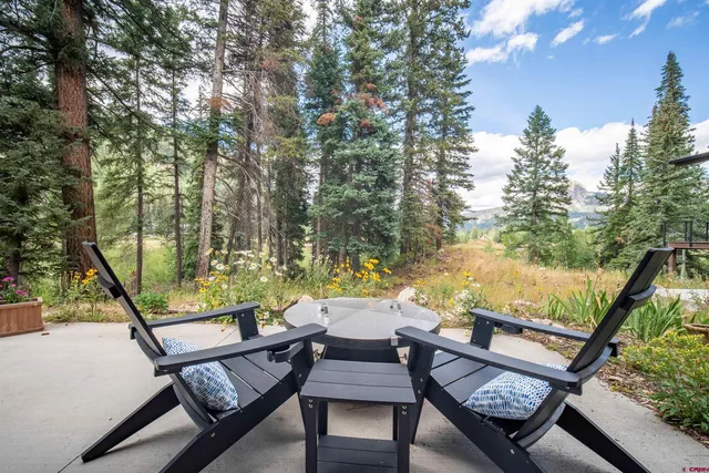 a view of a chairs and table in the balcony