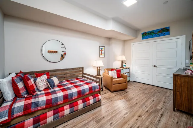 a bedroom with a bed and a chandelier