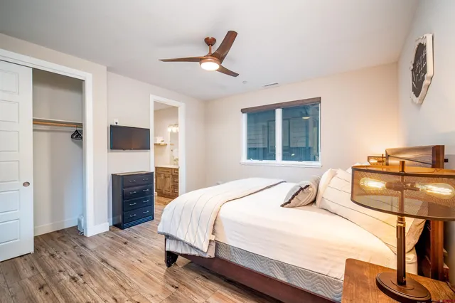 a bedroom with a bed and wooden floor