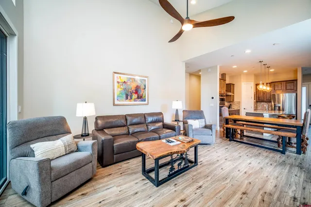 a living room with furniture and a wooden floor