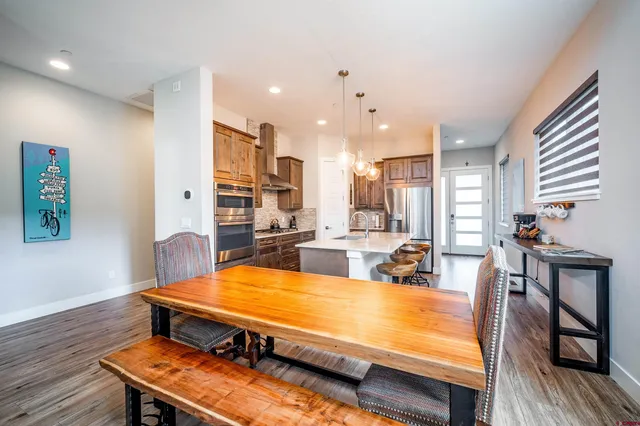 a view of a dining room with furniture and wooden floor