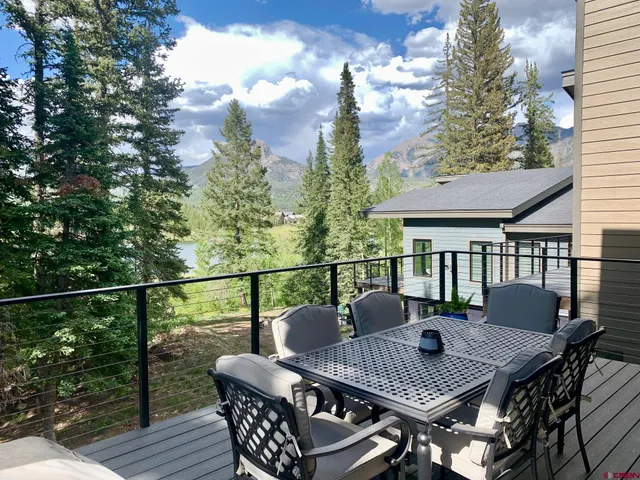 a view of a roof deck with furniture