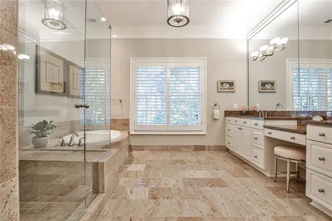 a bathroom with a granite countertop sink mirror and a bathtub