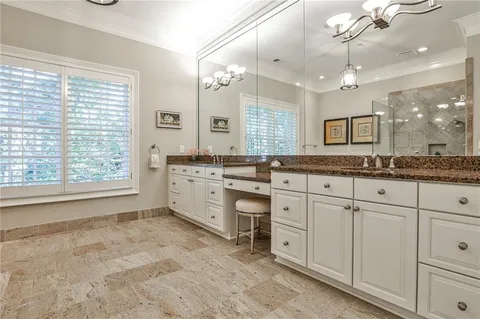 a spacious bathroom with a granite countertop sink mirror and a