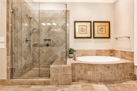 a bathroom with a bathtub and shower