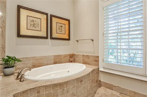 a bathroom with a tub and shower