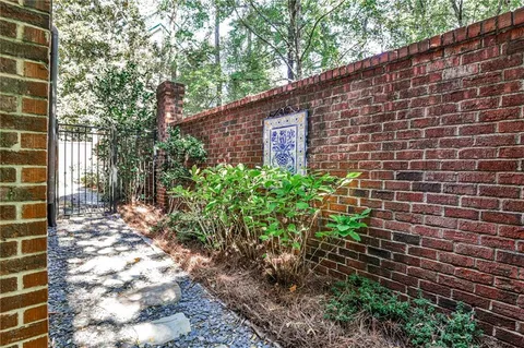 a backyard of a house with lots of green space and glass windows