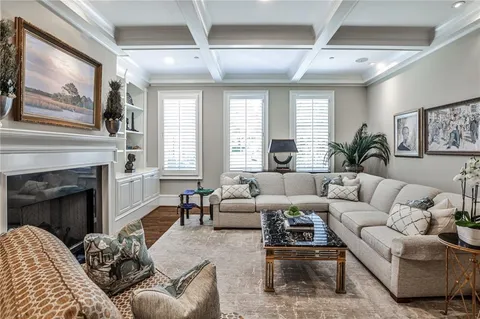 a living room with furniture a large window and a fireplace