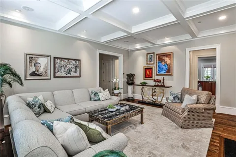 a living room with furniture ceiling fan and a rug