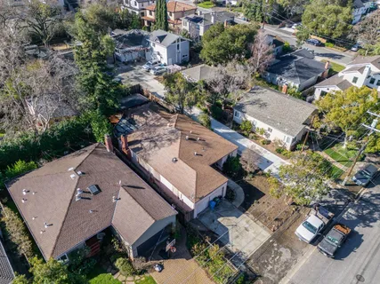 an aerial view of a house with a yard and lake view