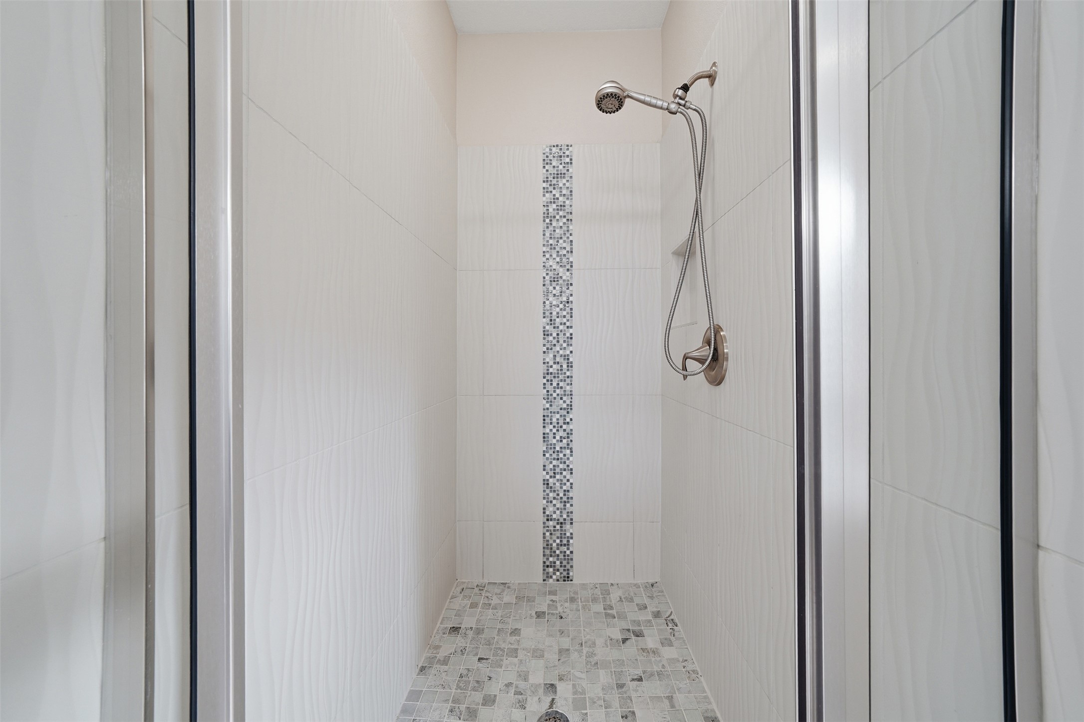 3901 Vaughan Street Austin, TX 78723 - Photo 26 of 37 Walk-in shower featuring a brushed nickel handheld showerhead and fixture