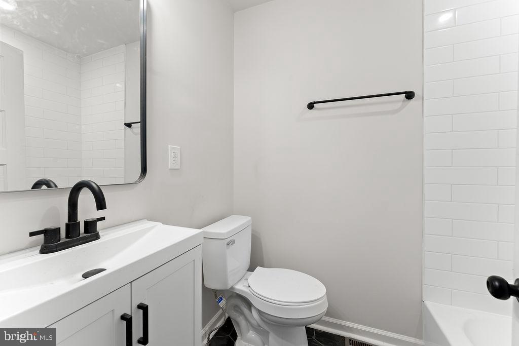 10221 Dahlgren Road King George, VA 22485 - Photo 12 of 31 a bathroom with a sink a toilet and a mirror