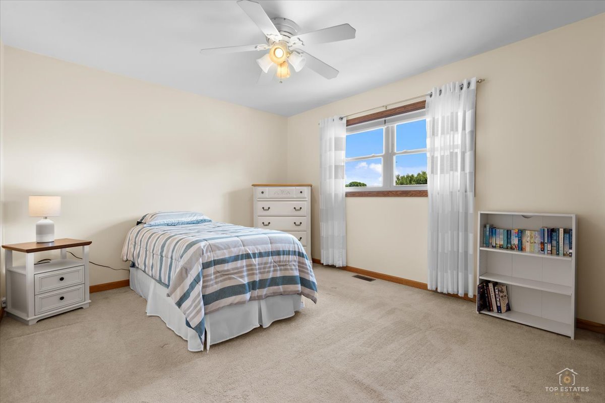 8124 Nottingham Road Tinley Park, IL 60477 - Photo 16 of 33 a spacious bedroom with a bed and a cabinets
