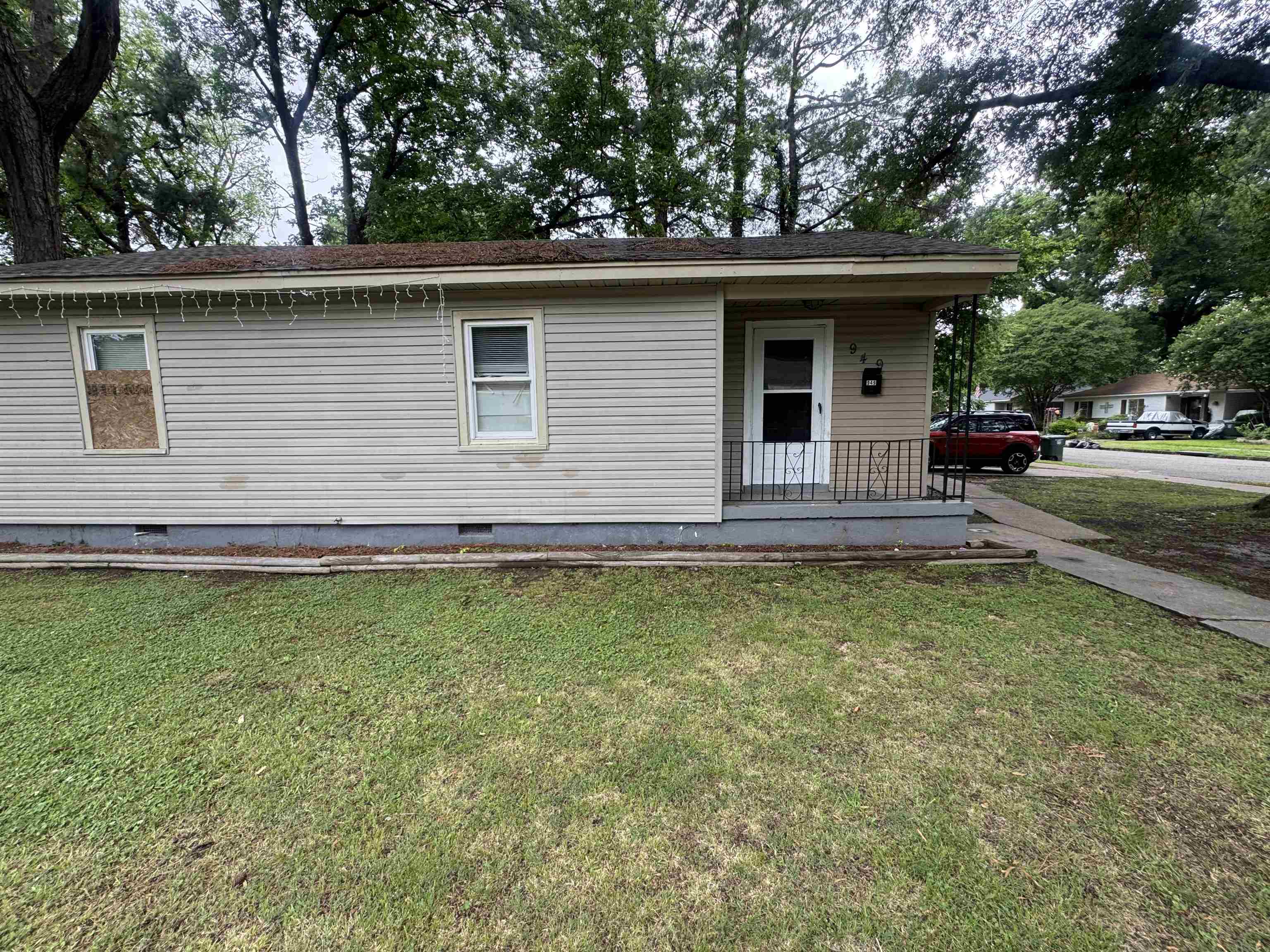 949 Sumter Street Memphis, TN 38122 - Photo 1 of 33 Single-story residence featuring siding exterior, a front entry porch with metal railings, and a concrete pathway