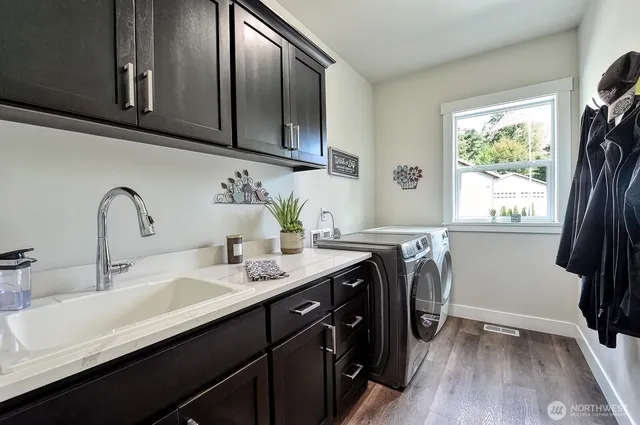 a bathroom with a double vanity sink and a window
