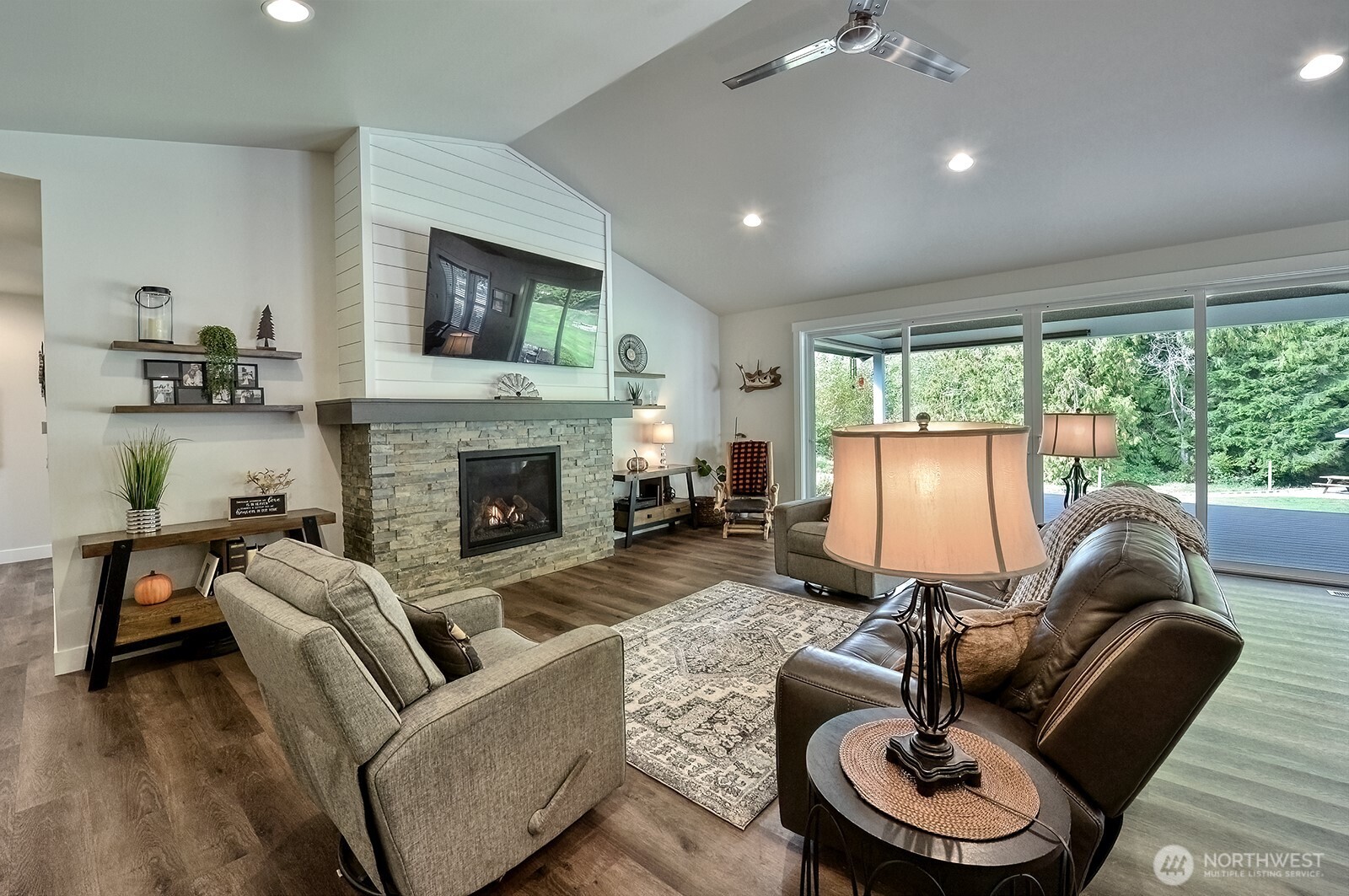 19443 Oakleaf Lane Sedro-Woolley, WA 98284 - Photo 15 of 40 a living room with furniture a fireplace and a floor to ceiling window