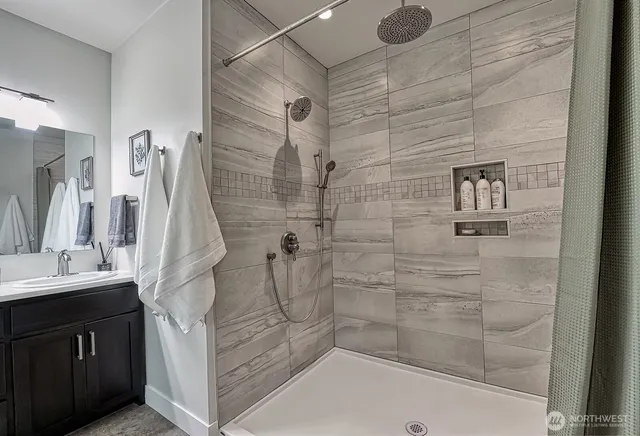 a bathroom with a sink a mirror and shower
