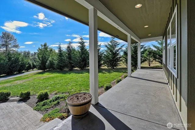 a view of a patio with a table and chairs