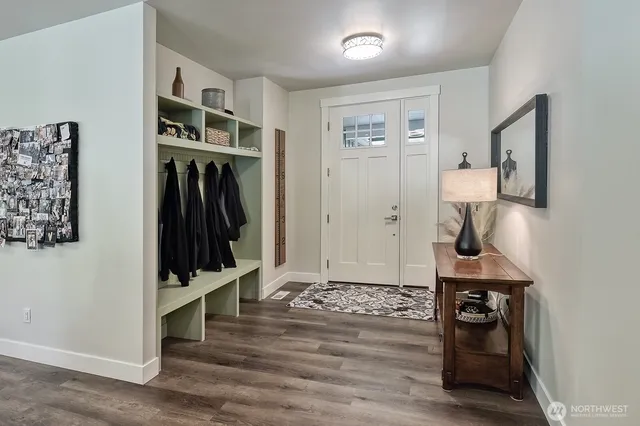 a view of a hallway with wooden floor and workspace