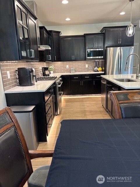 19443 Oakleaf Lane Sedro-Woolley, WA 98284 - Photo 8 of 39 a large kitchen with stainless steel appliances a sink a stove a refrigerator and cabinets