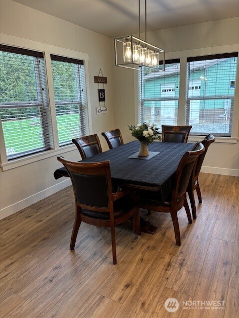 19443 Oakleaf Lane Sedro-Woolley, WA 98284 - Photo 9 of 39 a view of a dining room with furniture window and wooden floor