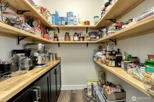 a kitchen with lots of clutter and cabinets