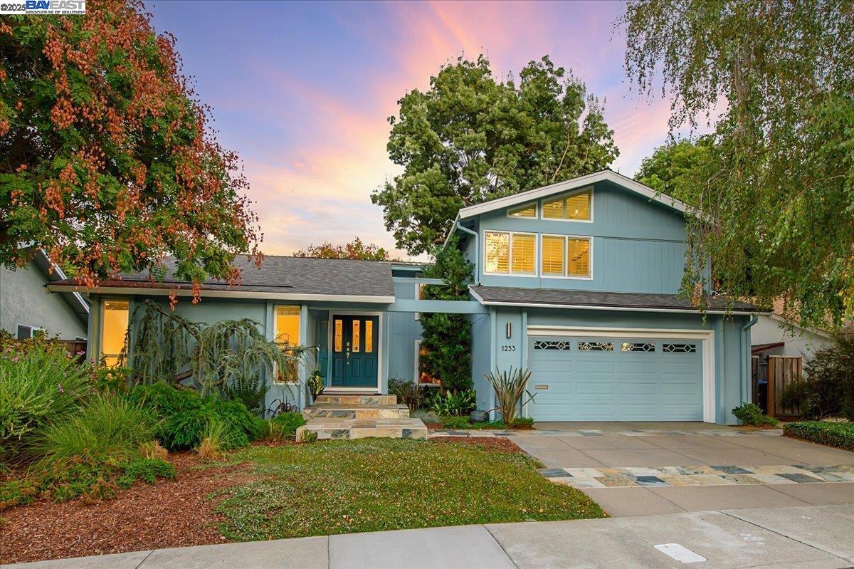 1253 Ridgewood Road Pleasanton, CA 94566 - Photo 1 of 1 a front view of a house with a garden and trees