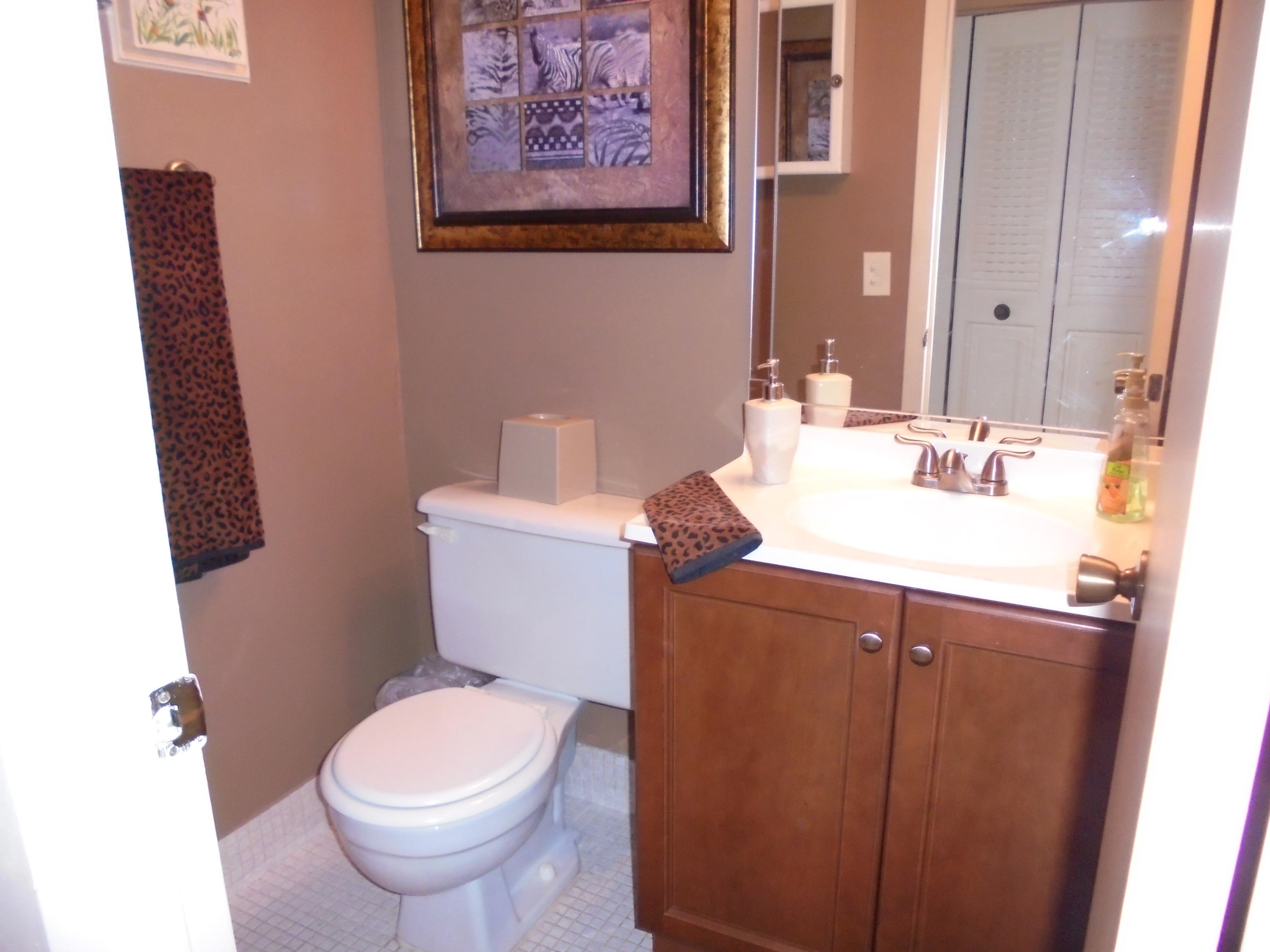 432 Mansfield K Boca Raton, FL 33434 - Photo 10 of 15 a bathroom with a toilet sink and mirror
