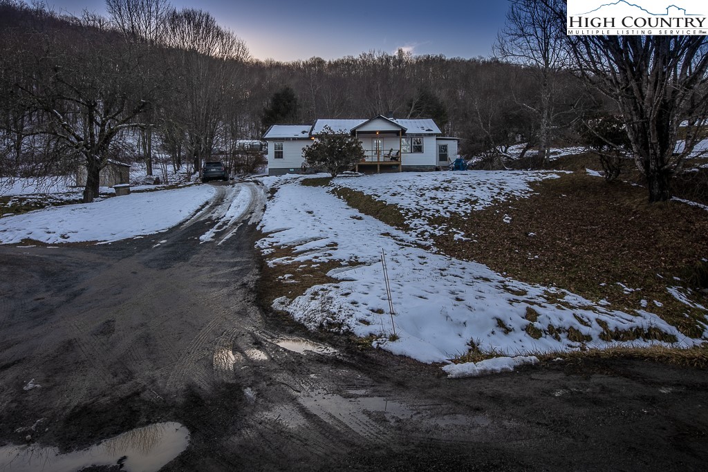 578 Charlie Hicks Road Banner Elk, NC 28604 - Photo 2 of 19 a view of a dirt yard with a large tree