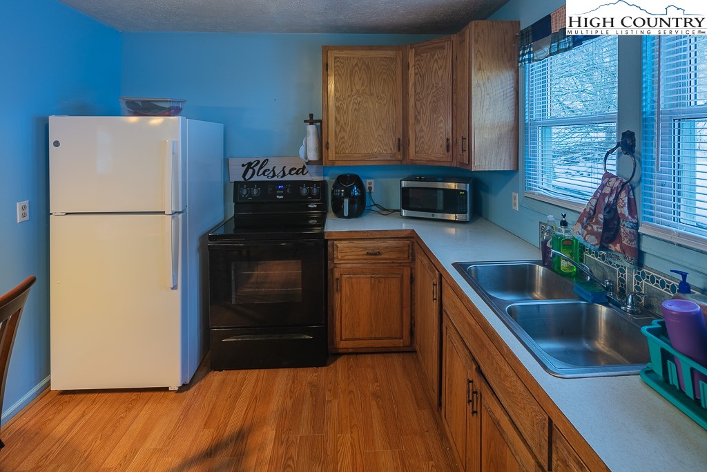 578 Charlie Hicks Road Banner Elk, NC 28604 - Photo 9 of 19 a kitchen with a refrigerator and a sink