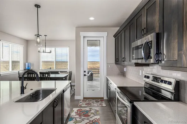 a kitchen with a sink stove top oven and cabinets