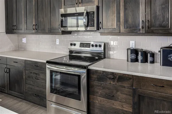a kitchen with a stove and a microwave