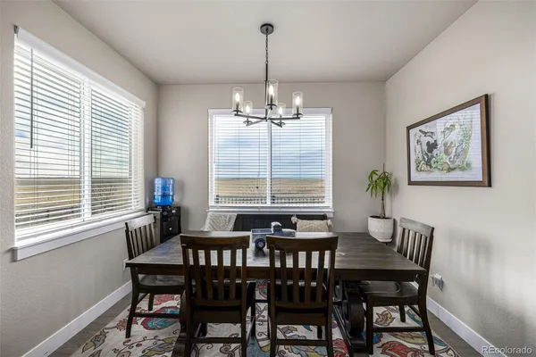 a dining room with furniture and window