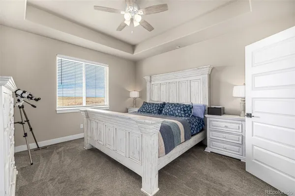 a spacious bedroom with a bed and a window