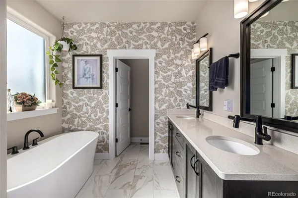 a bathroom with a tub sink and mirror