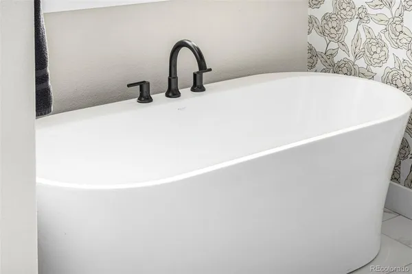 a white bath tub sitting in a bathroom